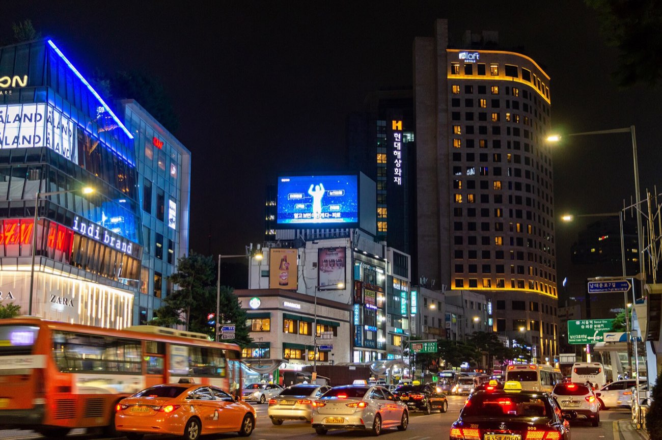 Crowded Myeongdong shopping street lit up at night